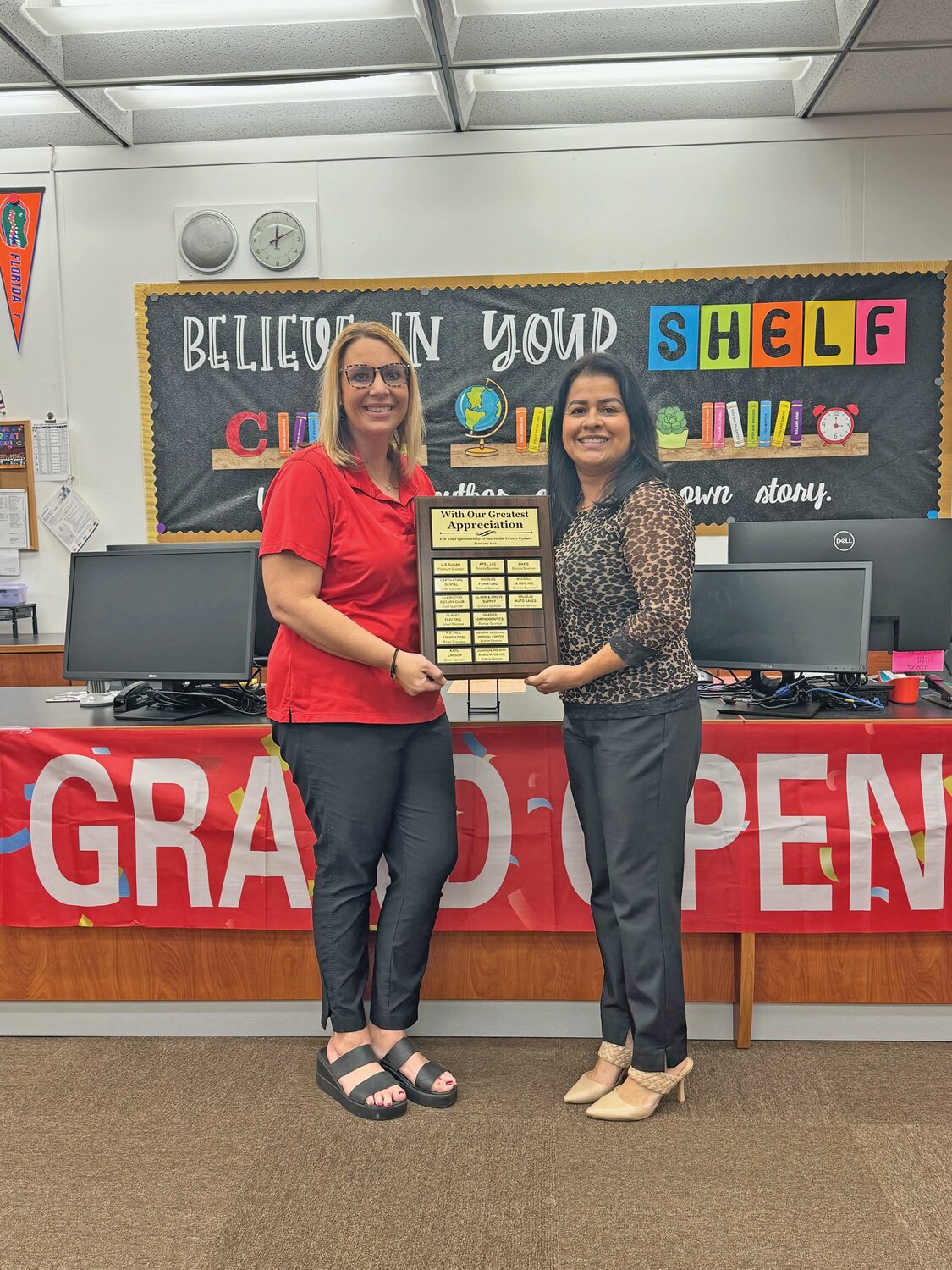 Central Elementary School Principal Melissa Carter and U.S. Sugar executive assistant Eneyda Rios at the recent grand re-opening of the Central Elementary School media center.